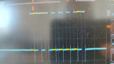 Photo of scope showing SCK signal (blue) and MOSI signal (yellow) during transmission of 0x61 single-byte message