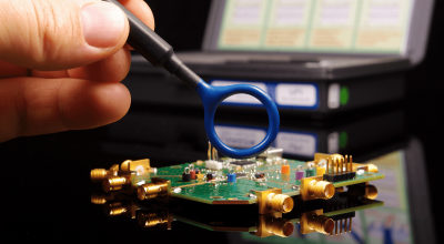 Electromagnetic compatibility (EMC) engineer holding magnetic near field probe for EMC troubleshooting and measurements (Custom).png